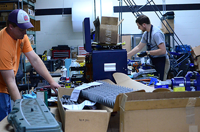 Chris Hord (left) and Ryan Lindell (right) work alongside McLean as armorers in the Custom Shop.