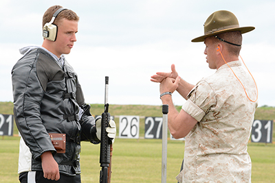 Members of the USMC shooting team used hands-on instruction on the firing line to guide juniors through competition techniques and safety practices.