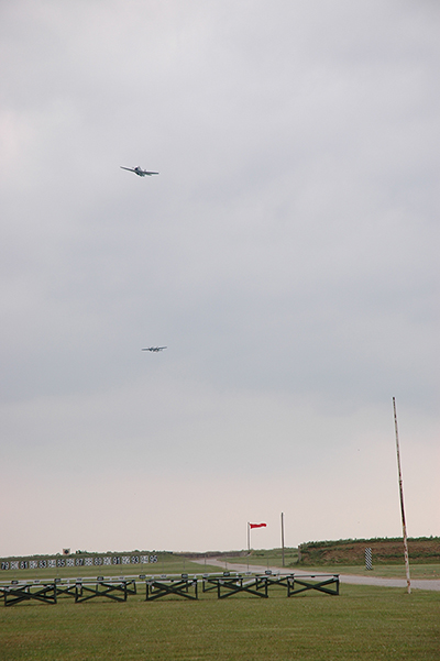 A World War II torpedo bomber and B-25 made four passes over the Camp Perry ranges. The planes opened their bomb doors and "dropped" explosives onto the ground fleet below.